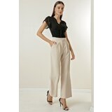 By Saygı A snap fastener at the waist, Pockets and Wide Leg Trousers. cene