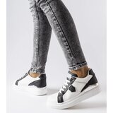 Gemre White and black sneakers with a silver accent Via | Shoptok.si