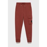 Calvin Klein Jeans Otroške trenirka hlače oranžna barva | Shoptok.si