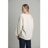 FASHION Beige oversize blouse with a decorative flower Cijene
