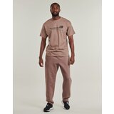 New Balance Spodnji deli trenirke LINEAR GRAPHIC FLEECE PANT Kostanjeva | Shoptok.si