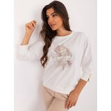 Fashion Hunters Ecru women's blouse with decorative buttons on the sleeve