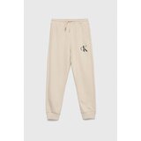 Calvin Klein Jeans Otroška bombažna trenirka bež barva | Shoptok.si