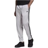 Adidas Spodnji deli trenirke Essentials Warm-Up Tapered 3-Stripes Bela | Shoptok.si