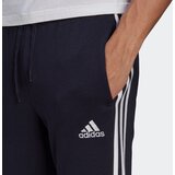 Adidas Športne hlače 'Essentials Fleece Tapered Cuff 3-Stripes' modra / bela | Shoptok.si