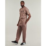 New Balance Spodnji deli trenirke LINEAR GRAPHIC FLEECE PANT Kostanjeva | Shoptok.si