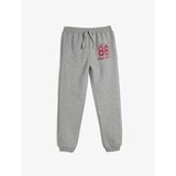 Koton Jogger Sweatpants with Tie Waist and Glitter Print Detail Cene