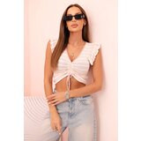 Kesi Women's ribbed blouse with gathering and ruffle powder pink Cene
