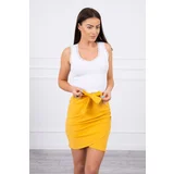 Kesi Wrap skirt tied at the waist with mustard