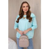 Kesi Cotton blouse with ruffles on the shoulders mint Cene