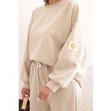 Kesi Włoski Ladies' butter set with a loose sweatshirt and pants with the word LOVE beige | Shoptok.si