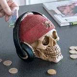 Hranilnik za denar lobanja s piratskim klobukom in slušalkami