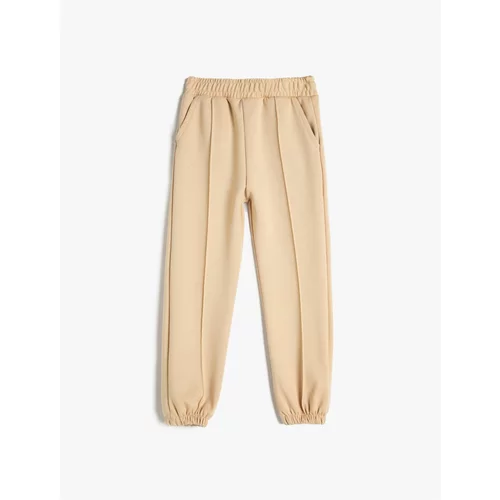 Koton Basic Jogger Trousers with ribs at the waist, elasticated waist and pockets.