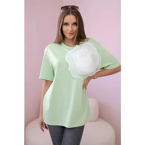 Kesi Cotton blouse with a decorative flower of light green color