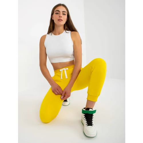 Fashionhunters Yellow smooth jogger pants with a tie detail