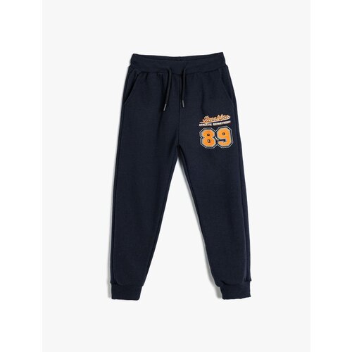 Koton jogger sweatpants with tied waist and sports print detail Cene