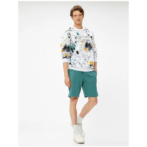 Koton Shorts with a tie-waist Slim Fit Shorts with Pockets and Printed Labels.