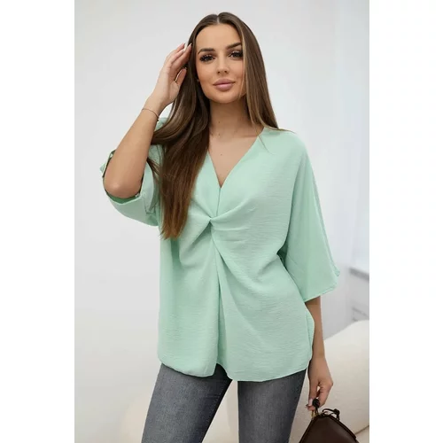 Kesi Oversized blouse with a light mint neckline