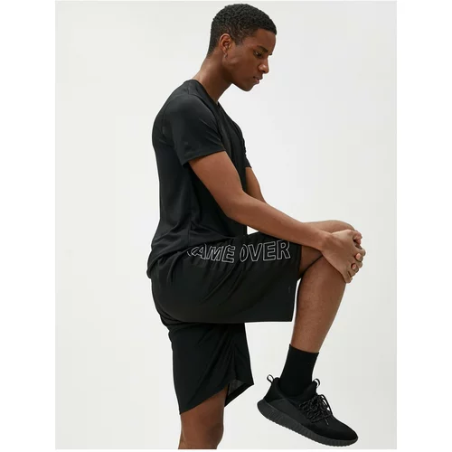 Koton Lace-Up Sports Shorts with Pocket Details with a Slogan Print.