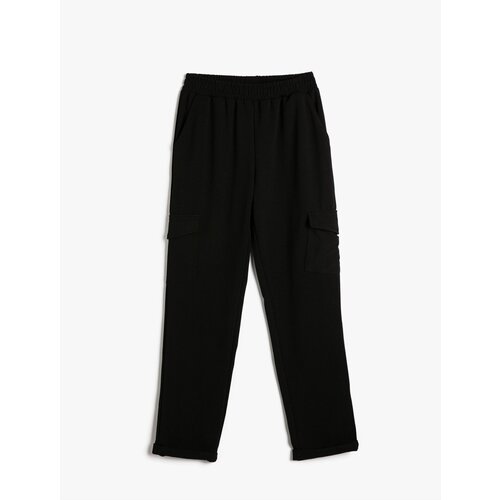 Koton Cargo Trousers have an elasticated waist, pocket detail, and fold over legs. Slike