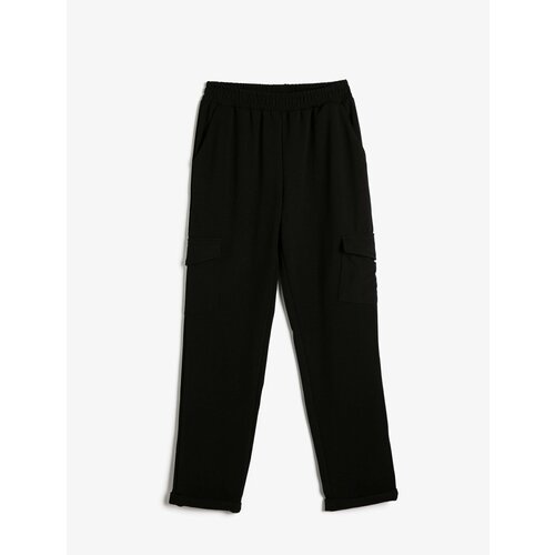 Koton Cargo Trousers have an elasticated waist, pocket detail, and fold over legs. Slike