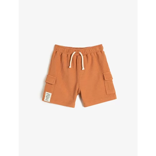 Koton The shorts are tied at the waist, elasticized, side pockets, textured cotton.