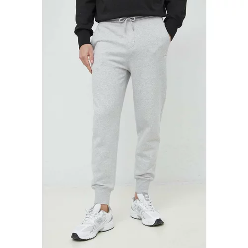 Calvin Klein Jeans Bombažen spodnji del trenirke moški, siva barva