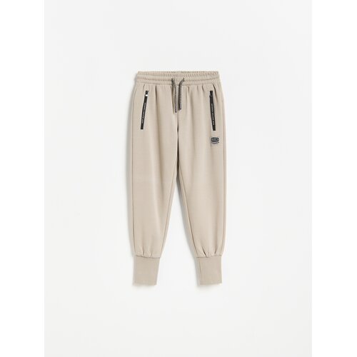Reserved Pamučne jogger hlače - bež Cijene