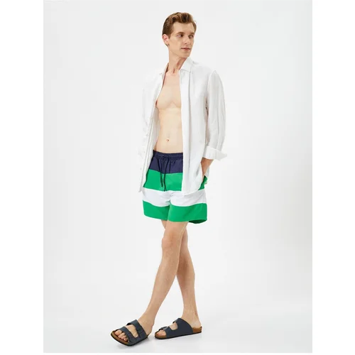 Koton Marine Shorts with Color Block with a drawstring waist and pocket.